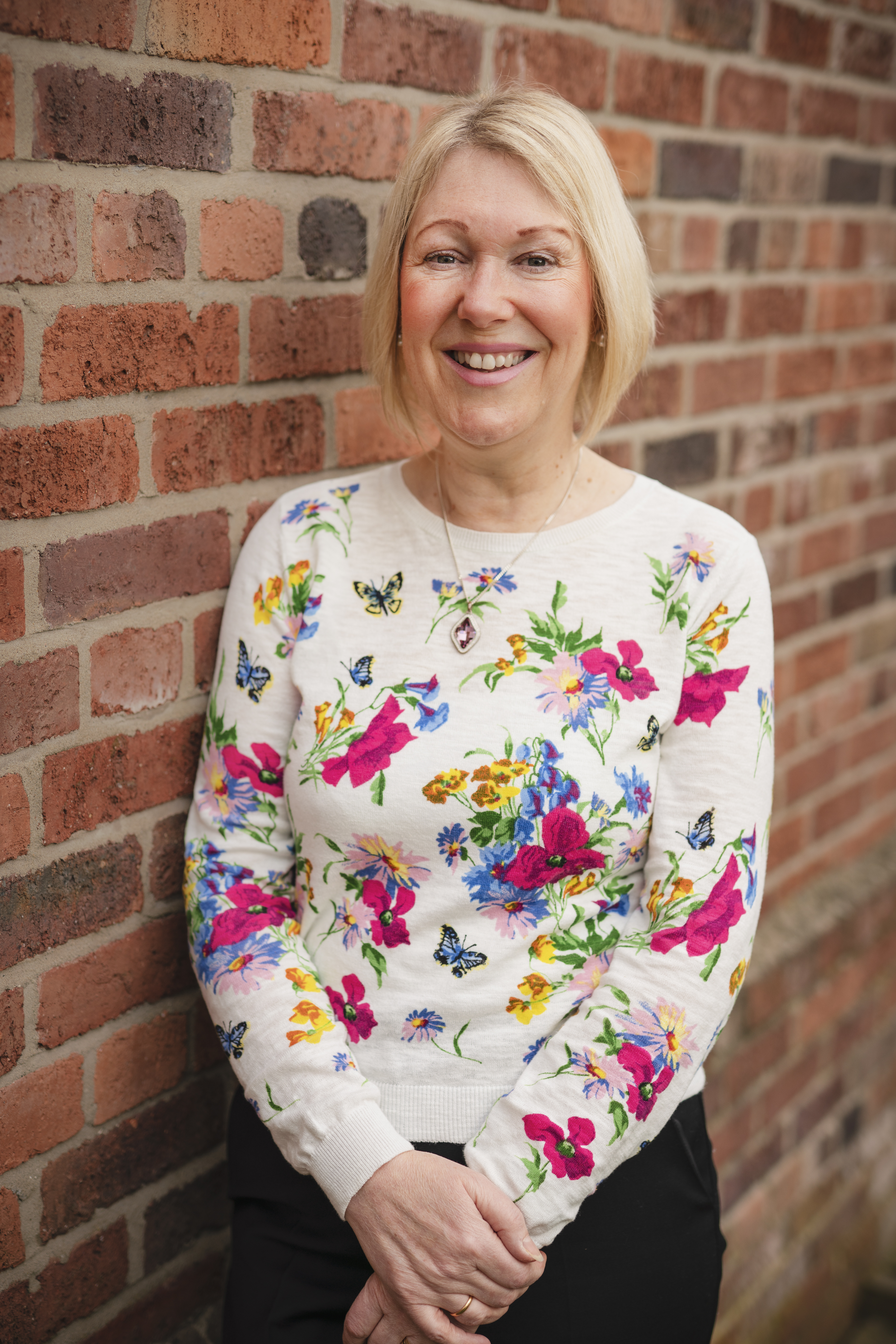 Photo- smiling by wall